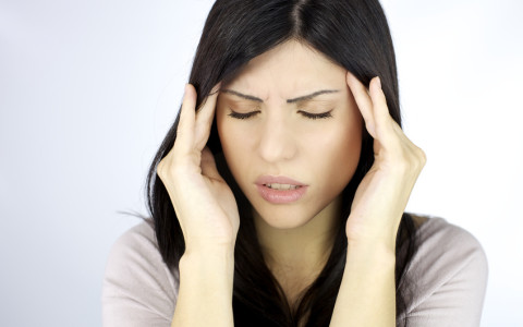 Closeup of woman with strong headache